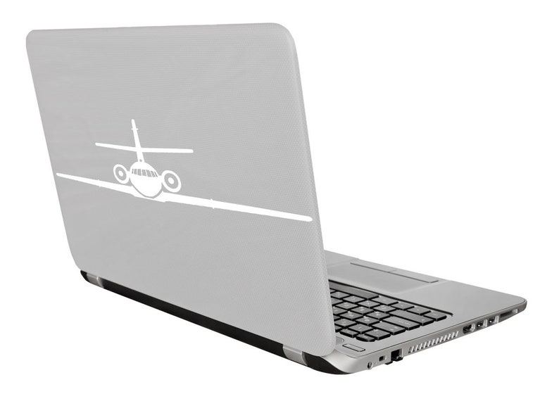 May include: A silver laptop with a white airplane silhouette on the lid. The laptop is closed and angled to the right.