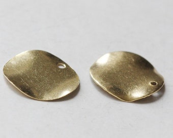 May include: Two gold-coloured metal charms in the shape of a slightly rounded square with a small hole in the top right corner.