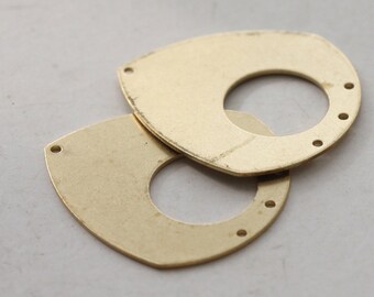 May include: Two gold-colored metal pendants with a rounded, teardrop shape and a hole in the center. Each pendant has five small holes around the edge.
