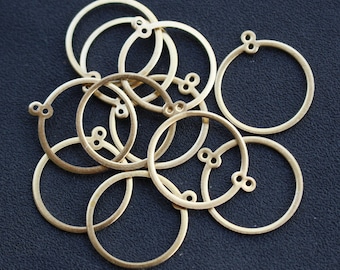 May include: A group of ten gold-colored metal rings with a small loop on each side. The rings are arranged in a random pattern.