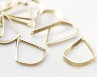 May include: A group of gold metal earring blanks in various shapes, including half circles and teardrop shapes.