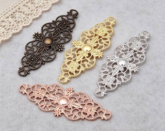 May include: Four elongated metal filigree connectors featuring intricate scrollwork, star accents, and a central circular cabochon setting. The set includes one dark bronze, one gold, one silver, and one rose gold finish piece for jewelry crafting.