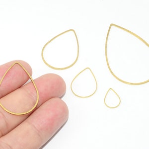 May include: Five gold teardrop-shaped wire hoops of varying sizes. The hoops are made of thin metal wire and are ideal for jewellery making.