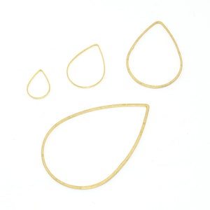 May include: Four gold teardrop-shaped wire hoops of varying sizes. The hoops are on a white background.