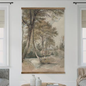 May include: A framed wall hanging featuring a watercolor landscape painting. The artwork depicts a serene scene with trees, a river, and soft, muted colors. The frame is made of wood, and the overall aesthetic is vintage and nature-inspired.