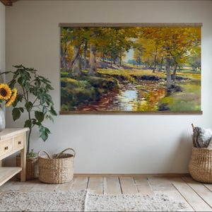 May include: A framed landscape painting depicts a serene forest scene with a stream reflecting the golden hues of autumn. The room features a wooden console table, a mirror, sunflowers in a vase, and woven baskets, creating a warm, inviting atmosphere.