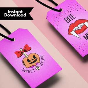 May include: Two pink gift tags with Halloween themes. One tag features a cartoon candy apple with a bow and the text "Sweet Stuff". The other tag features a cartoon vampire mouth with fangs and the text "Bite Me".