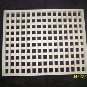 May include: A wooden lattice panel with a square grid pattern. The panel is made of light-colored wood and has a natural finish.