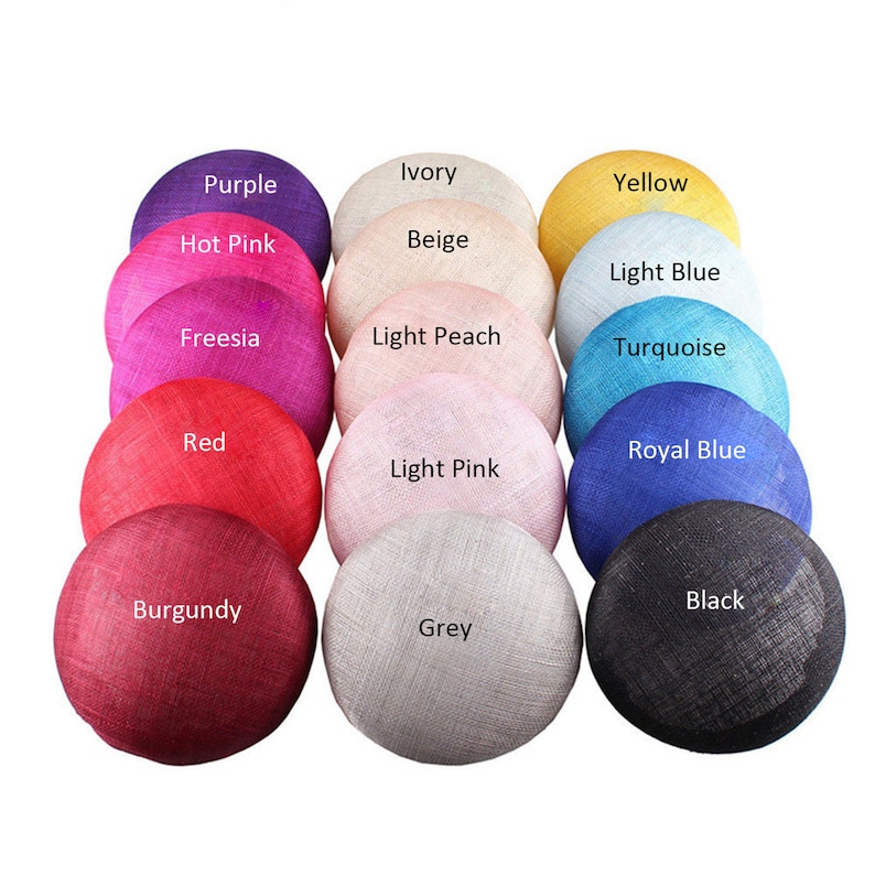 May include: A collection of round, woven fabric hat bases in various colors, including purple, hot pink, red, burgundy, ivory, beige, light peach, light pink, yellow, light blue, turquoise, royal blue, grey, and black. Each hat base has a color label.