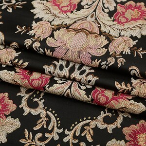 May include: Black fabric with a raised floral pattern in shades of pink, cream, and gold. The fabric has a damask-like design.