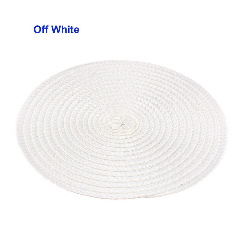 May include: Off-white, round woven placemat. The placemat is made of a natural fiber and has a spiral design. The text "Off White" is in the upper left corner.