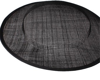May include: Black hat base made of woven straw material. The base is round and has a slightly curved brim.