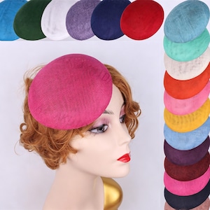 May include: A round, dome-shaped fascinator hat with a textured, woven surface. The main hat is a vibrant magenta pink. Surrounding the central image are multiple versions of the same hat in various colors, including blue, green, white, purple, navy, red, teal, yellow, and black.