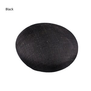 May include: A black, round hat with a woven texture. The word "Black" is printed in the upper left corner. The hat is a solid color and appears to be made of a natural fiber.