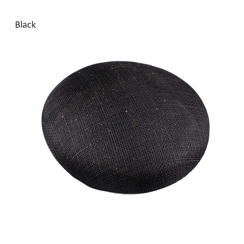 May include: A black, round hat with a woven texture. The word "Black" is printed in the upper left corner. The hat is a solid color and appears to be made of a natural fiber.