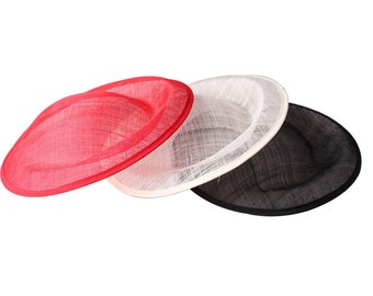 Puede incluir: Tres bases de sombrero en rojo, blanco y negro. Las bases son de material tejido y son redondas y planas.