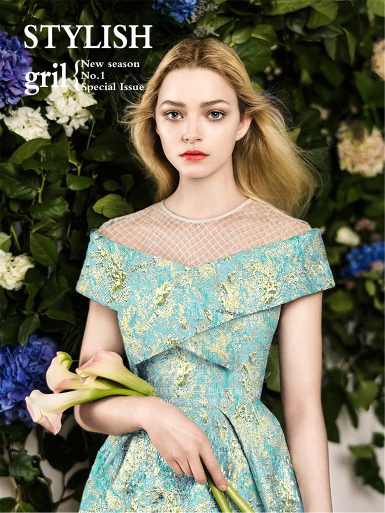 May include: A woman in a turquoise and gold patterned dress with a sheer neckline holds calla lilies. The image is from a magazine cover with the text "STYLISH gril" and "New season No.1 Special Issue."