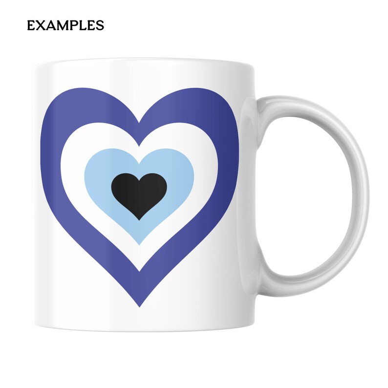 May include: A white ceramic mug featuring a large, centered heart graphic composed of concentric layers. The design consists of a dark blue outer heart, a white middle layer, a light blue inner layer, and a solid black heart at the very center.