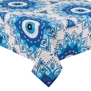 May include: Blue and white tablecloth with a repeating pattern of stylized evil eyes and floral designs.