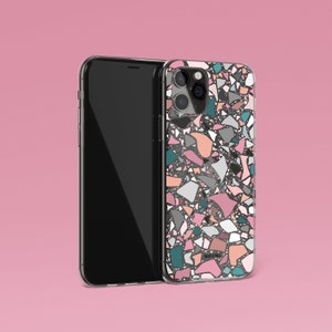 K&ouml;nnte beinhalten: Ein Smartphone mit einer transparenten H&uuml;lle mit einem farbenfrohen Terrazzo-Muster in Rosa, T&uuml;rkis, Grau und Pfirsich. Das Telefon befindet sich vor einem rosa Hintergrund. Auf der H&uuml;lle steht "TALK & TELL".