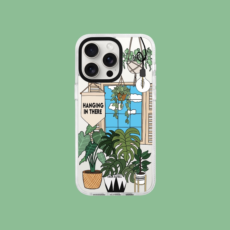 May include: A phone case featuring a colourful illustration of plants and a window with the text "Hanging in there".