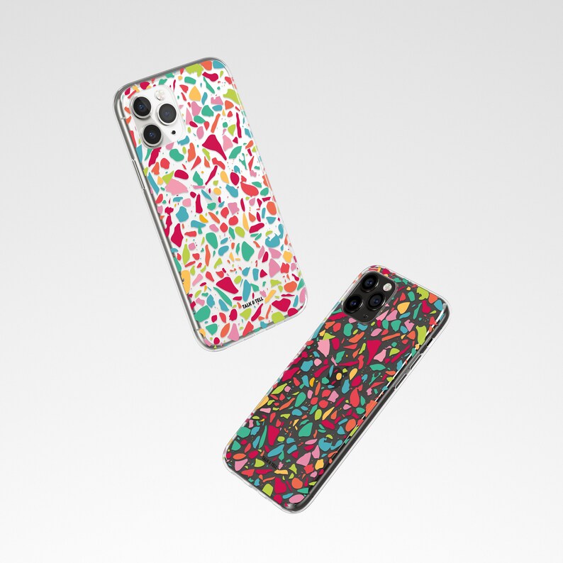 May include: Two clear phone cases with a colorful terrazzo pattern. The case on the left has a white background and the case on the right has a black background.