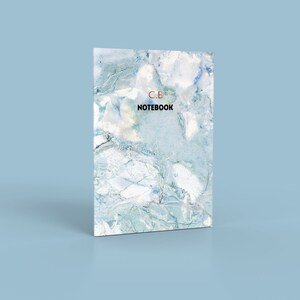 May include: A blue and white marble notebook with the text "C.B. NOTEBOOK" printed on the front cover.