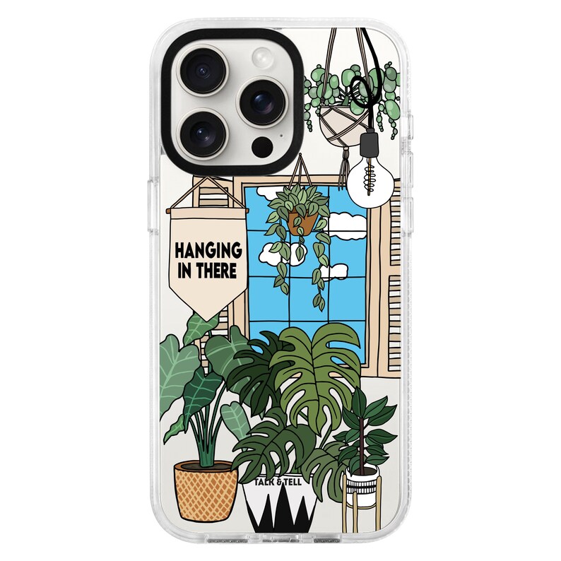 May include: A clear phone case with a white background and a colourful illustration of plants and a window with the text "Hanging in there".