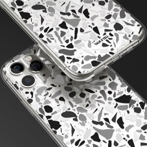 May include: A clear phone case with a black and white terrazzo pattern. The case has the words "Talk & Tell" printed on the back.