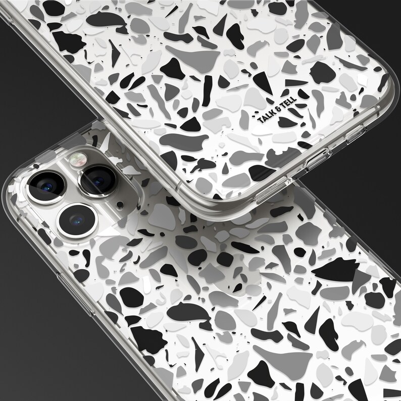 May include: A clear phone case with a black and white terrazzo pattern. The case has the words "Talk & Tell" printed on the back.