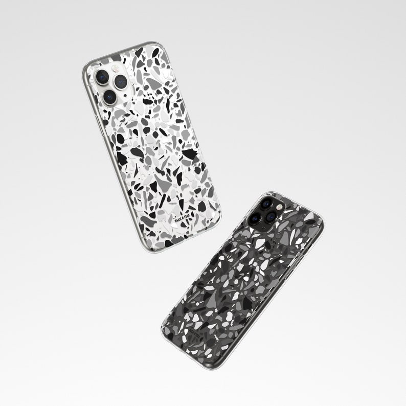 May include: Two clear phone cases with a black and white terrazzo pattern. The cases are designed for an iPhone with a camera bump.