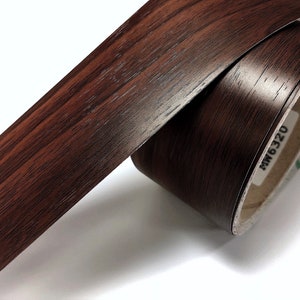 May include: A roll of brown wood-grain contact paper with the text "MW6320" printed on the roll.