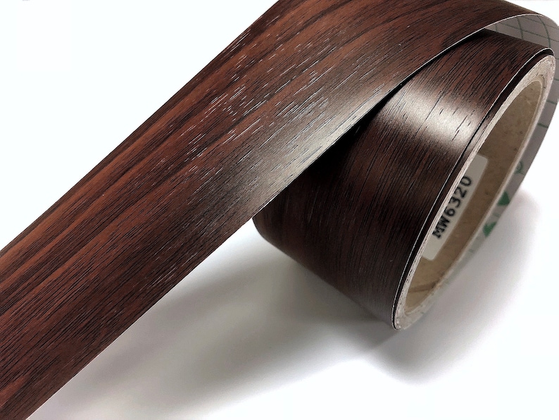 May include: A roll of brown wood-grain contact paper with the text "MW6320" printed on the roll.