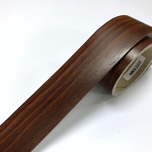May include: A roll of brown wood-grain contact paper with the product code "MW 6320" printed on the label.