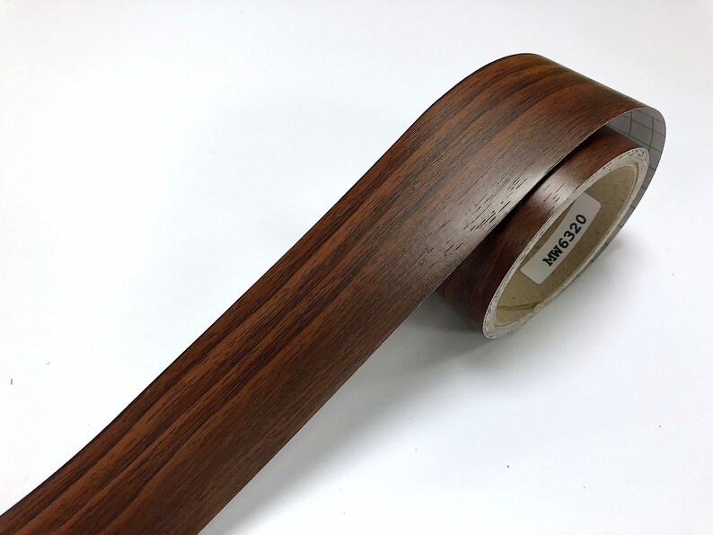 May include: A roll of brown wood-grain contact paper with the product code "MW 6320" printed on the label.