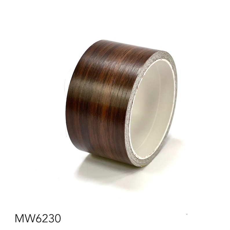 May include: A roll of brown woodgrain contact paper with a white core. The paper has a woodgrain pattern and is designed to look like real wood.