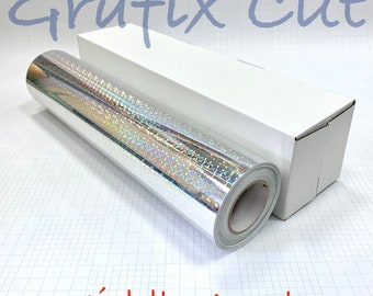 Pode incluir: Um rolo de vinil holográfico prateado com um núcleo branco, etiquetado como "Grafix Cut" e "Middle Angle".