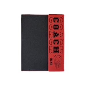 May include: Black and red volleyball coach's binder. The red cover features the word "COACH" in bold, black lettering, along with a volleyball and net graphic. The word "NAME" is also printed on the cover. The binder is closed.