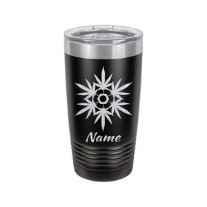 May include: Black stainless steel tumbler with a silver lid. The tumbler has a white design of a marijuana leaf snowflake with the word "Name" below it.