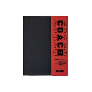 May include: Black and red notebook with the word "COACH" in bold, black letters. The red portion has a swimmer graphic and the word "NAME" below it. The notebook is designed for a coach.