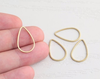May include: Four gold-colored teardrop-shaped metal hoops. The hoops are about 1 inch in diameter.