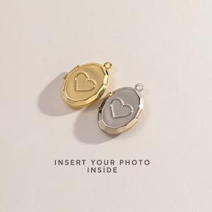 May include: Two oval-shaped lockets, one gold and one silver, each with a heart design. The gold locket is on the left, and the silver locket is on the right. The text "INSERT YOUR PHOTO INSIDE" is below the lockets.