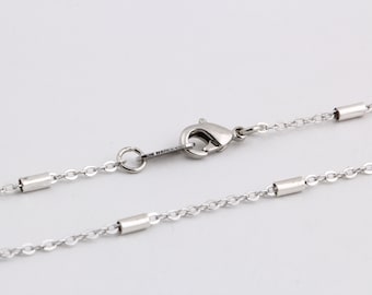 May include: A silver chain necklace with a lobster clasp and small silver tube accents.