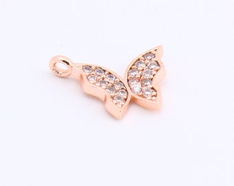 May include: A rose gold butterfly charm with clear crystal accents. The charm has a loop at the top for attaching to a necklace or bracelet.