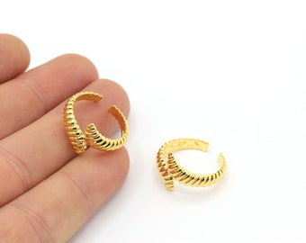 May include: Two gold-toned adjustable rings with a textured, rope-like design.
