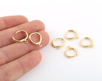 May include: Six gold-toned earring hoops with a jump ring closure. The hoops are approximately 1 inch in diameter.