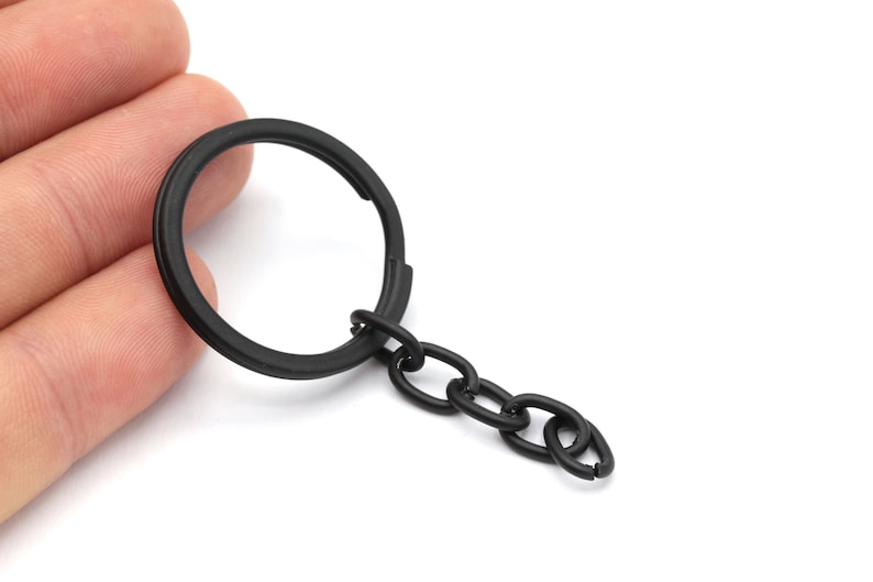 May include: A black key chain with a round metal ring and a short chain.
