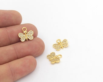 May include: Three gold butterfly charms with clear rhinestone accents. The charms are perfect for jewelry making or adding a touch of sparkle to crafts.
