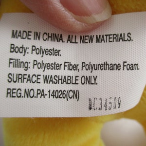 May include: A white tag with black text that reads "MADE IN CHINA. ALL NEW MATERIALS. Body: Polyester. Filling: Polyester Fiber, Polyurethane Foam. SURFACE WASHABLE ONLY. REG.NO.PA-14026(CN)" and a black number "C34509".