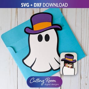May include: A white ghost wearing a purple and orange top hat, with black eyes, on a light blue background. A small wooden cutout of the ghost is also present. The image includes the text "SVG + DXF DOWNLOAD" and "Cutting Room digital designs".